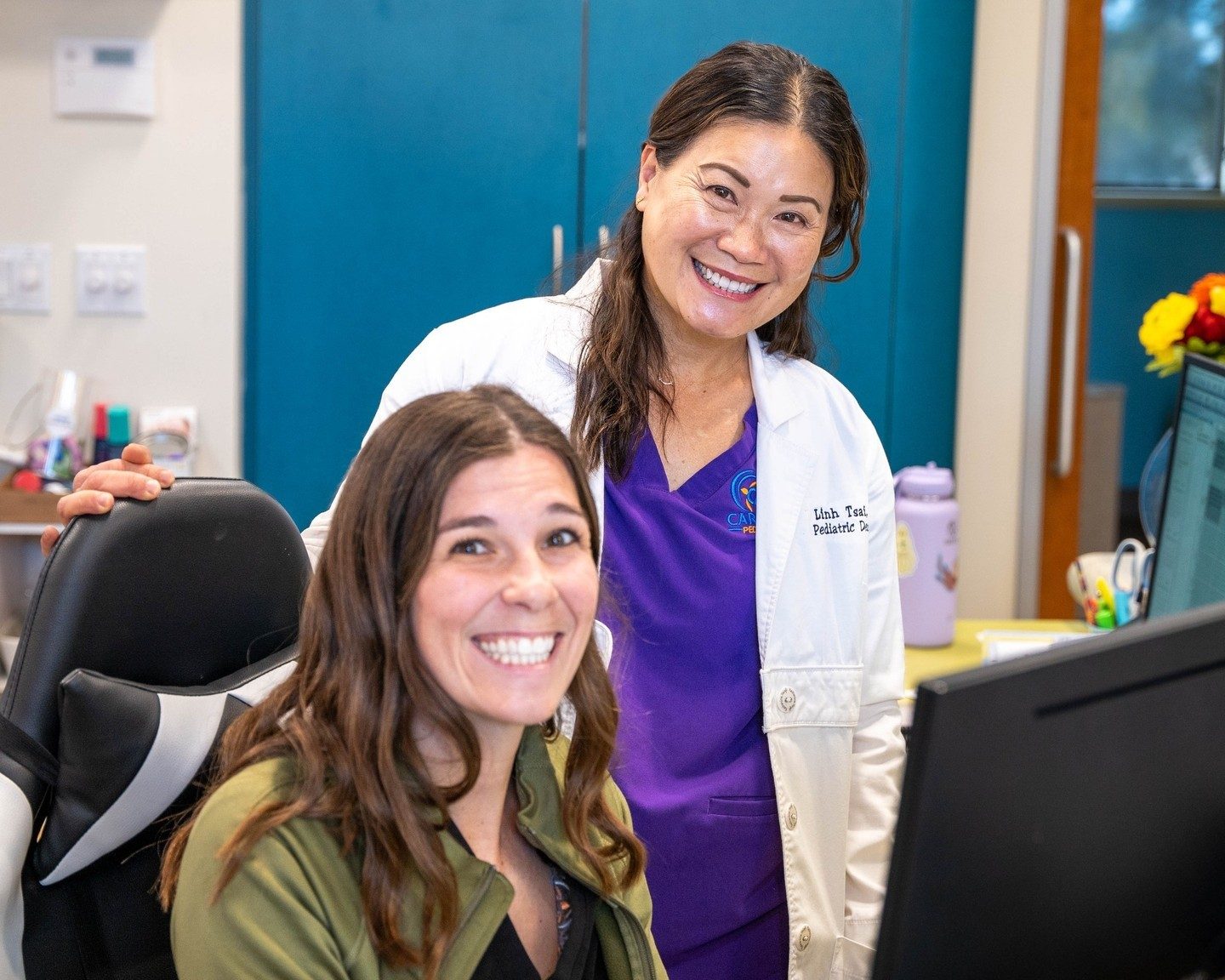 Dr. Tsai with a front-office team member at the reception desk