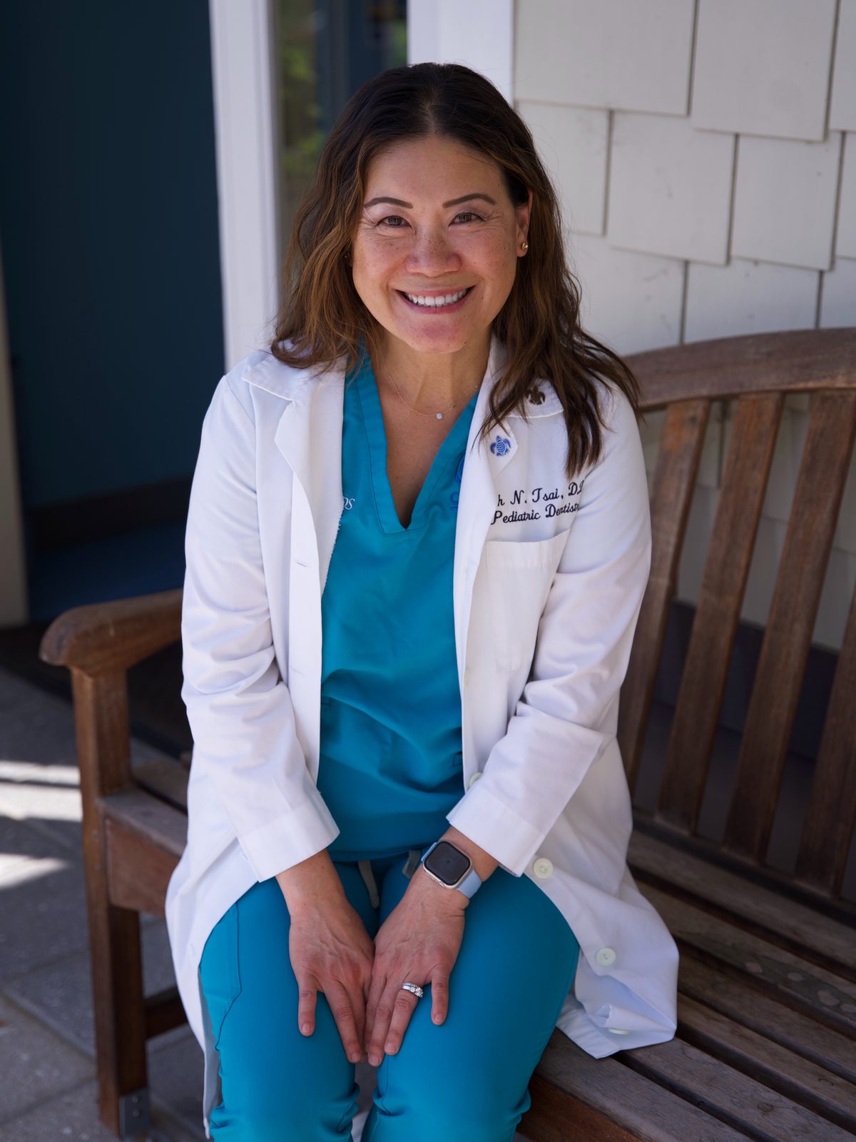 Dr. Linh Tsai, founder of CarlsbaDDS Pediatric Smiles, outside the office