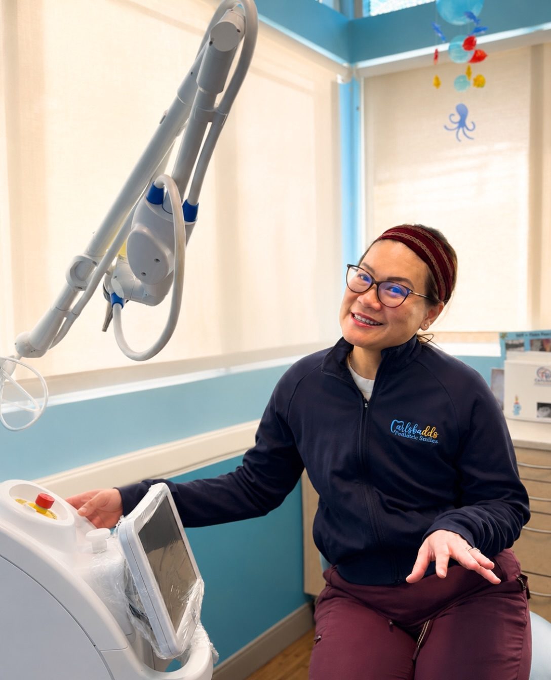 Dr. Linh Tsai beside the practice’s Solea dental laser