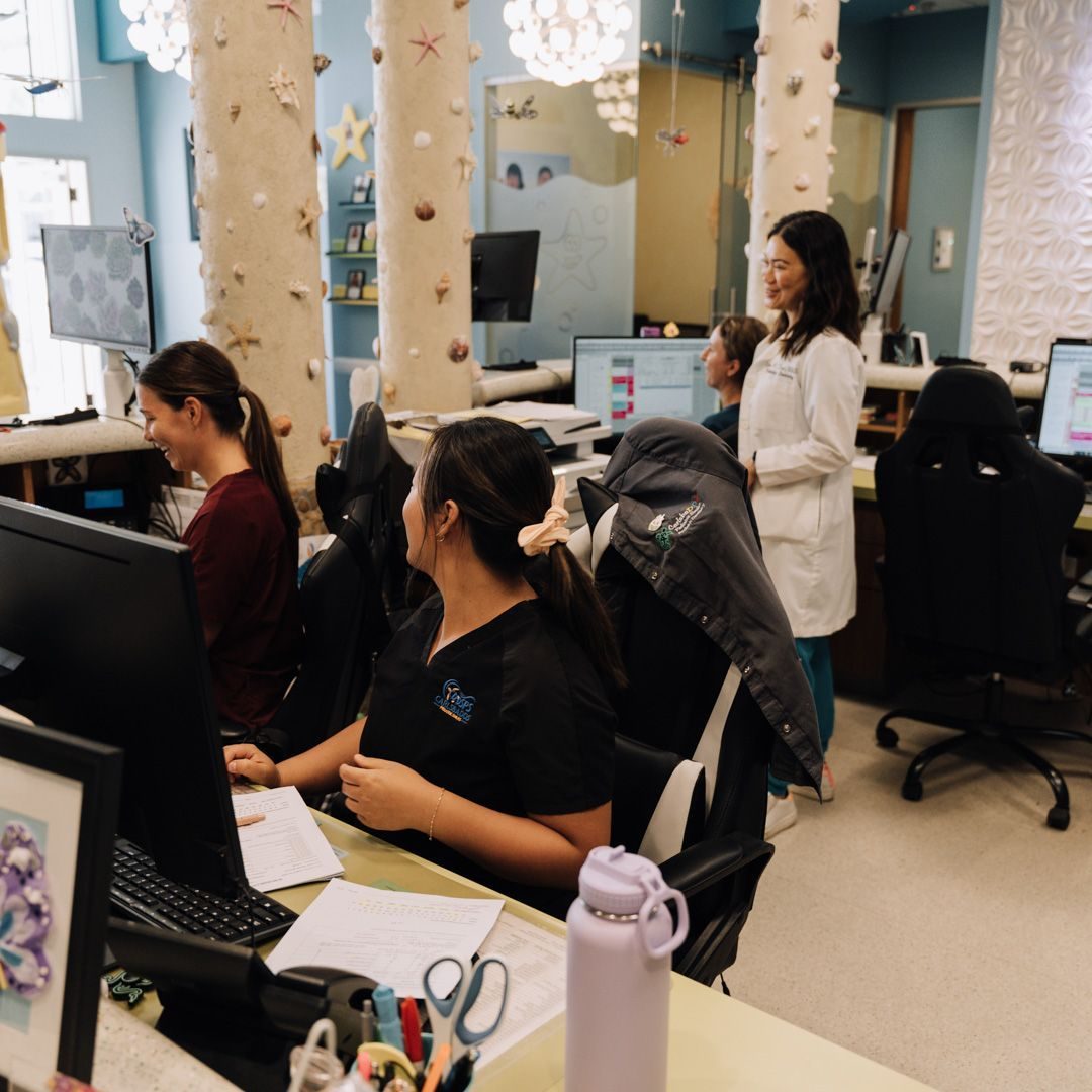 The front-desk team at work in the shell-columned reception area