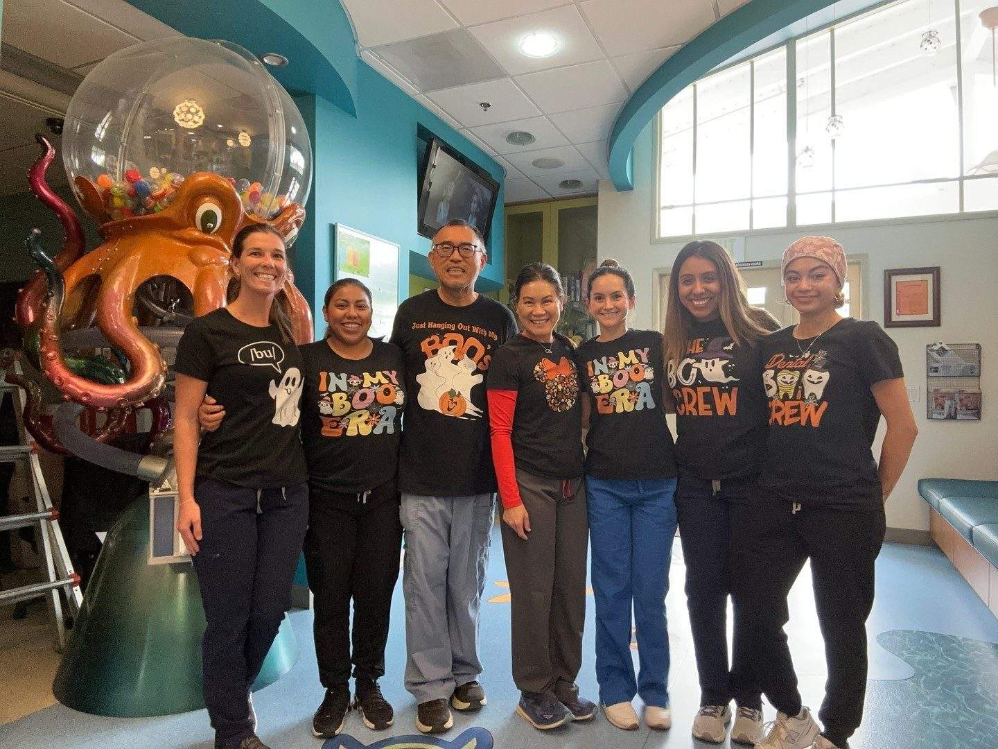 The team in Halloween shirts in the office lobby