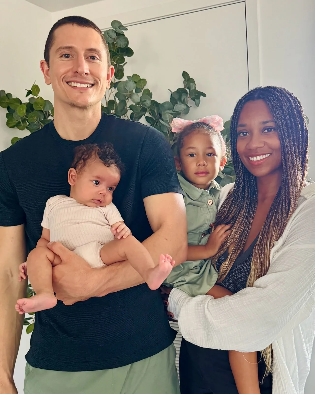 Dr. Najwa Howard at home with her husband, their daughter and baby Selah